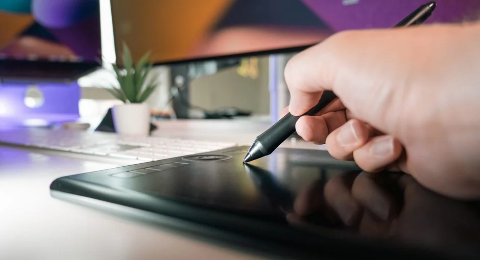 Close-up of hands interacting with a shopping website on a laptop screen indoors.